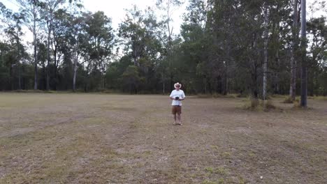 drone flying towards old man low altitude man has to duck to avoid being hit