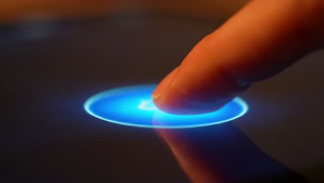 an engaging interaction: a finger touches a glowing circular interface on a touchscreen device, capturing a moment of technology in action