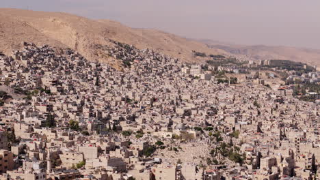 drone slides sideways over damascus, syria during daytime, revealing the city’s architecture, streets, and urban layout from above
