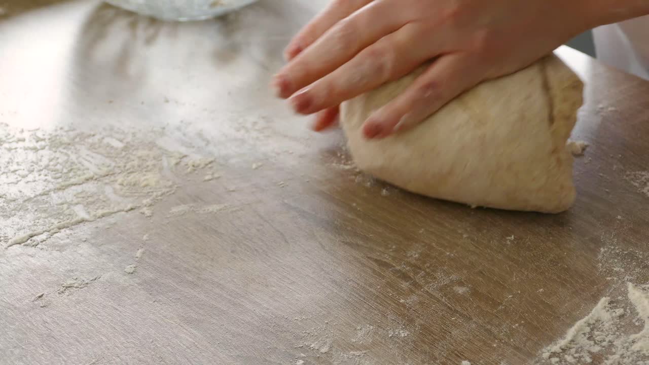 FEMALE HANDS KNEADING BREAD
