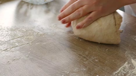 female hands kneading bread