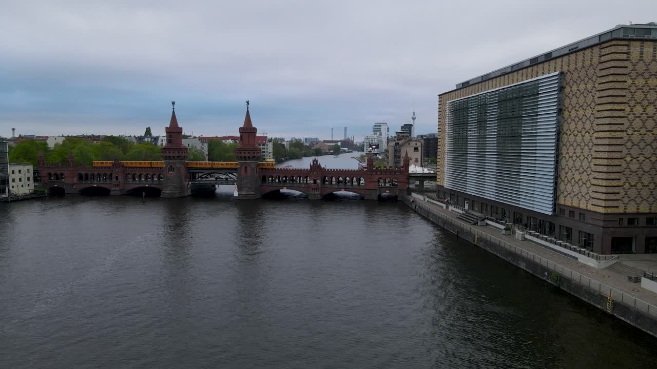 Drone Flying over the river Spree in Berlin, towars the famous Oberbaumbrücke