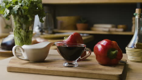 red bell peppers and balsamic glaze on wooden cutting board