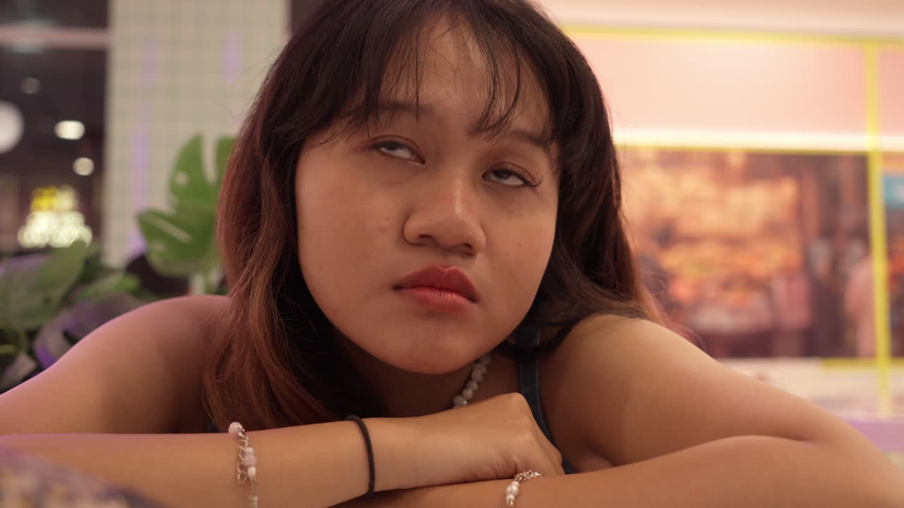 Young Teenage Girl Rolling Her Eyes And Looking Sad After Glancing At Her Phone.