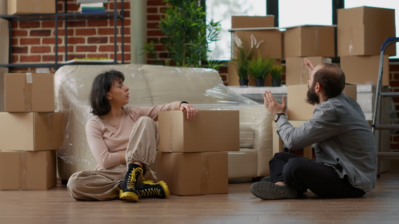 Man and woman disapproving with each other after home relocation