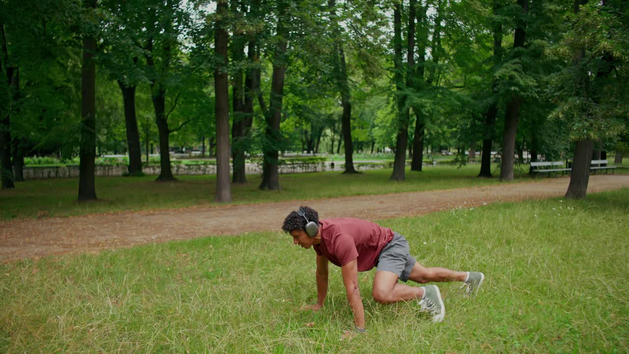 Man exercising in park with headphones