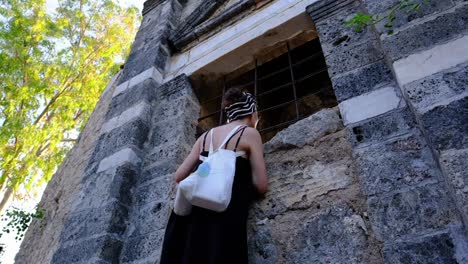 woman looks into a historical building