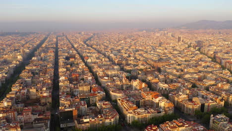 Aerial-view-of-square-blocks-in-new-quarter-of-Barcelona-at-sunrise,-Spain