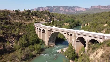 aerial drone view of gallego river, scenic road and mallos de riglos rock formations at huesca, spain