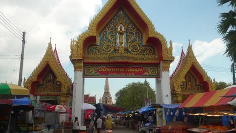 chalong buddhist temple main entrance with street market at phuket bangkok