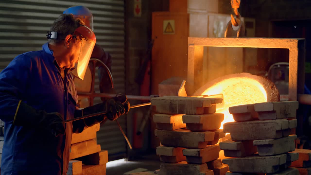 4k 워크 ⁇ 에서 컨테이너에서 분해 된 금속을 혼합하는 남성 노동자