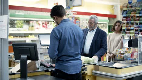 people buying goods in supermarket