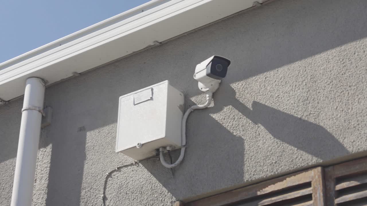 A surveillance Camera on the side of a building