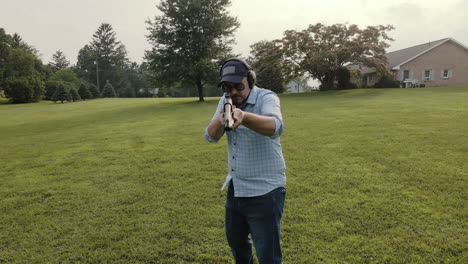 man firing shotgun toward camera