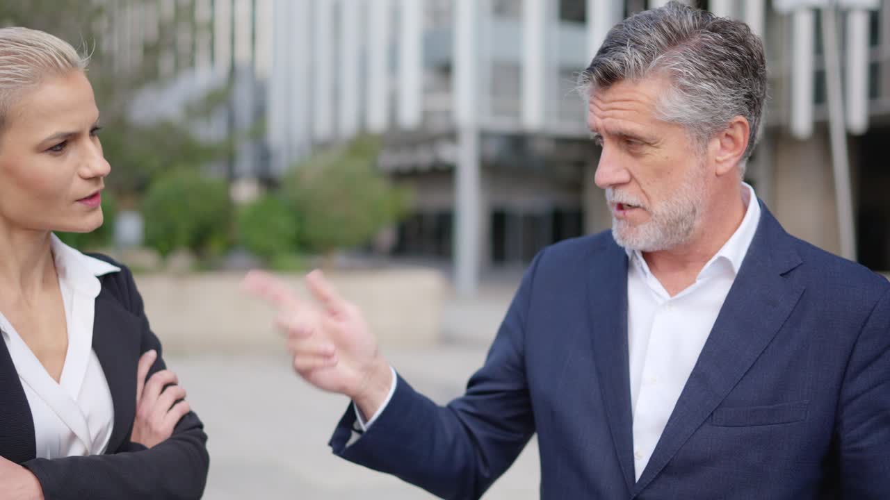 Business professionals in a heated discussion outdoors