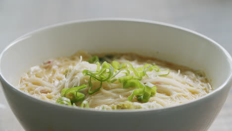 Medium-close-shot-of-a-bowl-of-thai-rice-noodle-soup