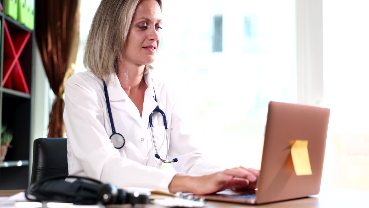 Female doctor using laptop at work