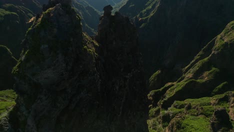 Aerial-of-volcanic-mountains-with-steep-rocky-cliffs-during-sunrise