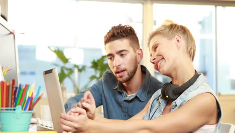 smiling casual businesswoman explaining work to colleague