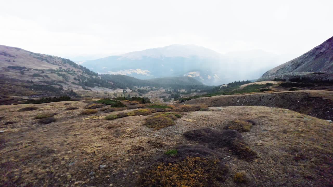Hail falls over rugged mountain ridges in a cinematic view of Colorado’s wilderness