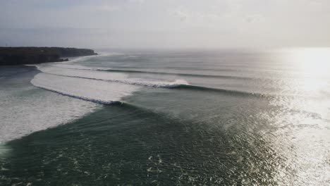 uluwatu bali island surf famous spot destination aerial view at sunrise with huge ocean waves