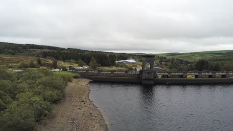 Alwen-reservoir-industrial-hydroelectric-landmark-historical-rural-lake-dam-building-aerial-descending-shot