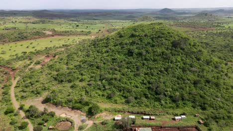 agricultural farmland with lush mountain in background during sunny day in kenya, africa