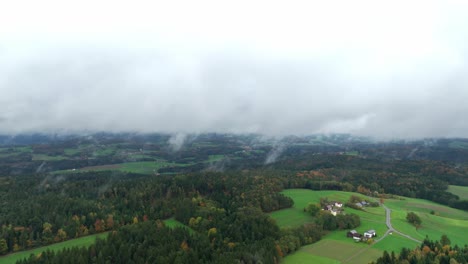 Foggy-Clouds-Over-Autumn-Forestland-Near-Countryside