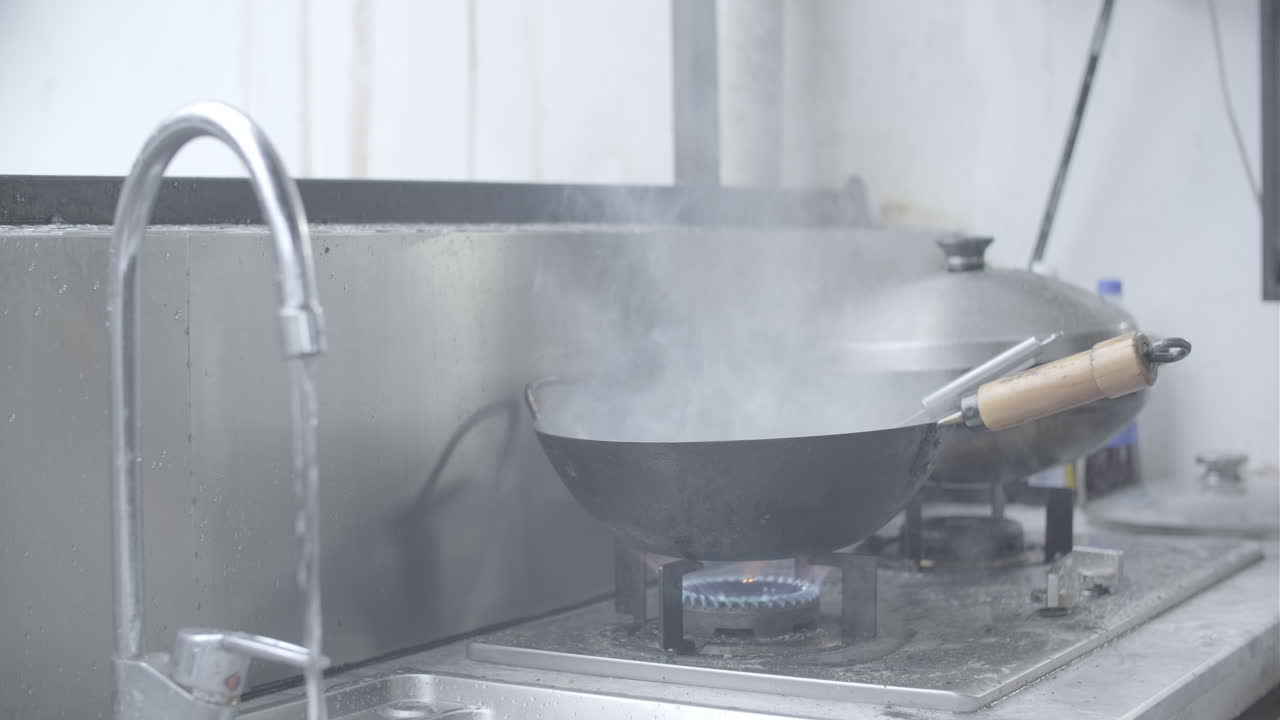 Wok on stove with fire on. Chinese Cooking Techniques Concept