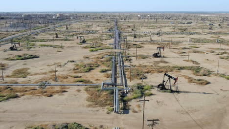 long pipeline for oil in large oil field, aerial view