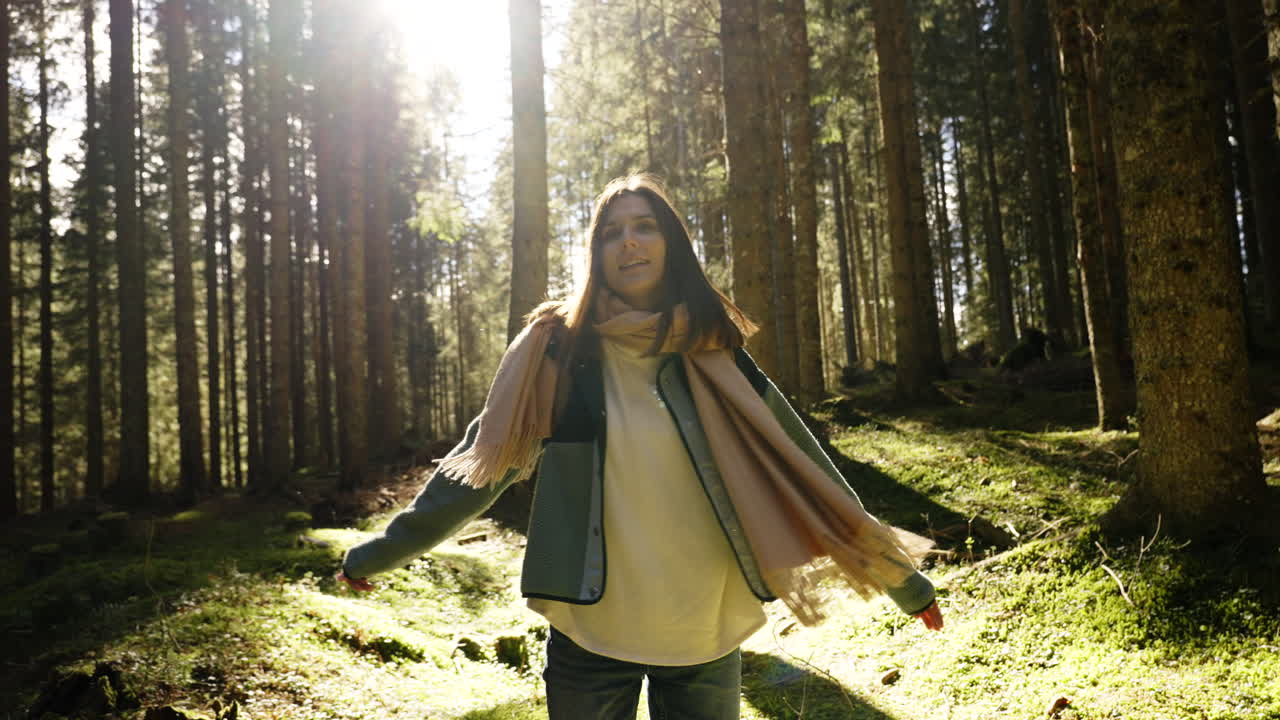 Woman enjoying a sunny day in the forest