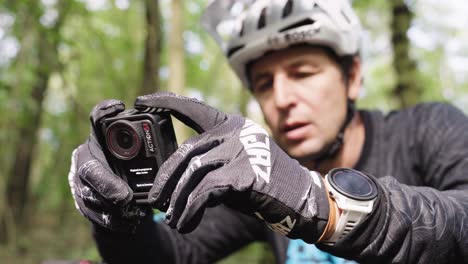 man mountain biking and recording with action camera