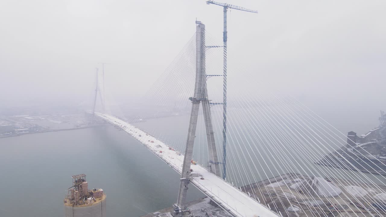 Aerial view of fog covered Gordie Howe Bridge connecting Detroit, USA and Windsor, Canada