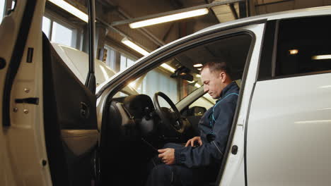 mechanic working on a car interior