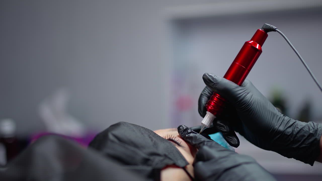 Permanent eyebrows correction. Permanent make up specialist working with skin patient.