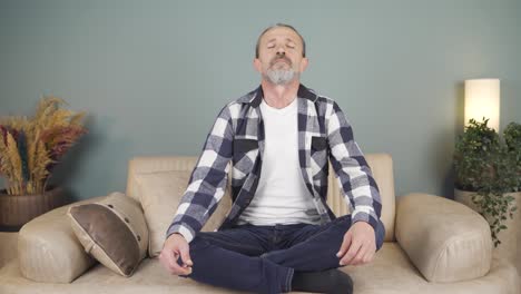 Man-meditating-looking-at-camera.