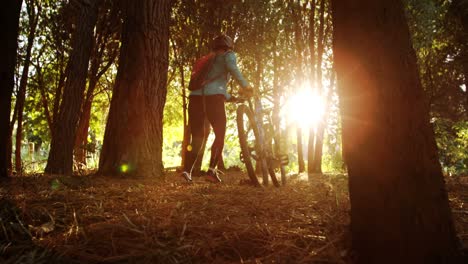 Female-mountain-running-walking-with-bike