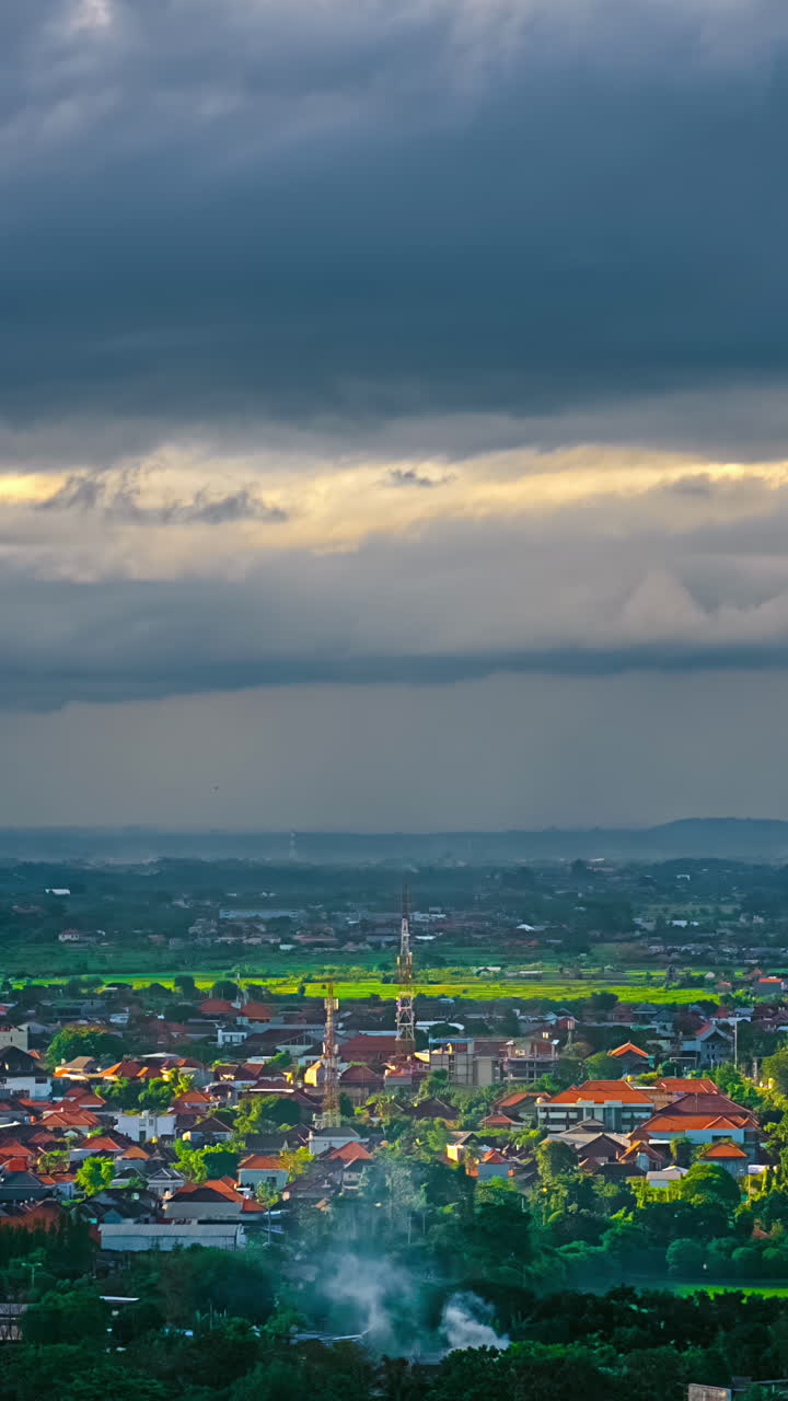 Drone hyperlapse over Kuta Selatan as storm clouds form and rain, vertical