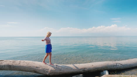 Carefree-Woman-Walking-On-A-Log-Balancing