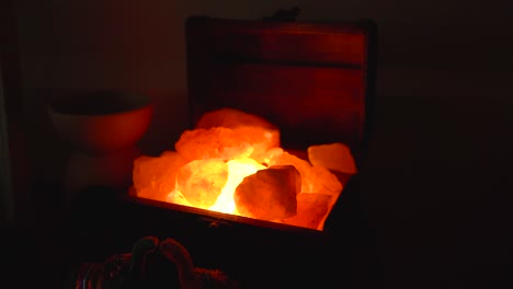 Golden-Light-Shining-Through-Large-Rocks-Of-Himalayan-Salt-Lamp---high-angle-shot