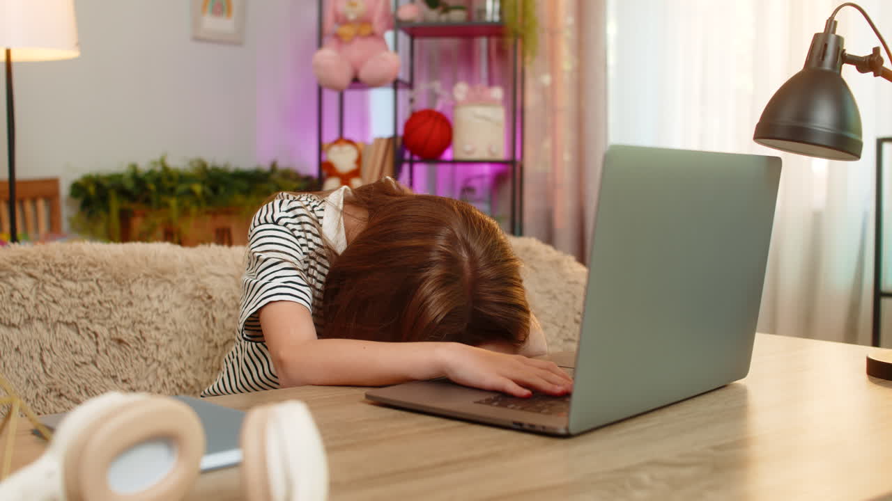 Child girl kid angry at home after losing online quiz game at table with laptop upset reaction