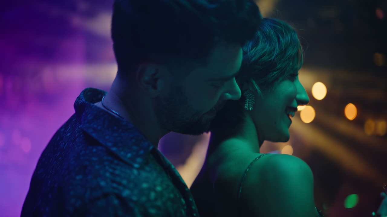 Sensual couple moving bodies at night party closeup. Handsome man hugging woman