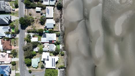 Aerial-drone-top-down-shot-Beachmere-beach-and-sand-banks,-camera-flying-to-the-right-looking-straight-down-at-Town,-beach,-Sand-Banks-and-Ocean-water