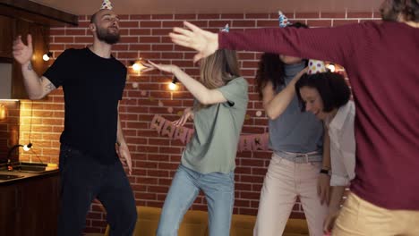 young people dancing out rocking birthday party celebrating exciting holiday at home, slowmo