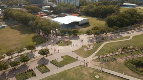 aerial orbiting view of a roundabout in vicente lopez coastal walk and a sport club behind