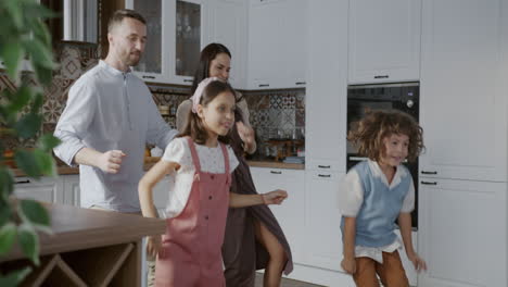 happy family dancing in the kitchen