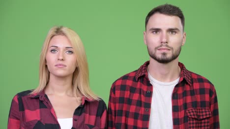 young sad man thinking together with young happy woman