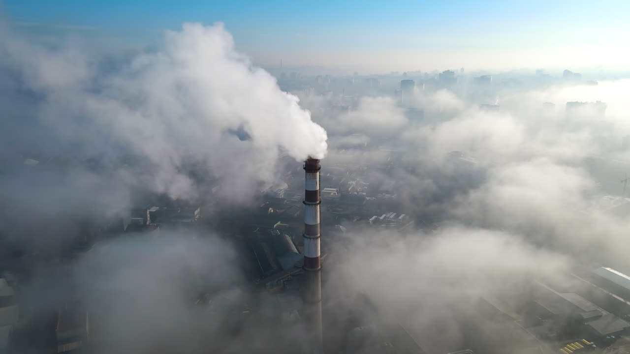 Aerial drone view of Chisinau. Thermal station with smoke coming out of the tube. Buildings, roads. Low clouds. Moldova