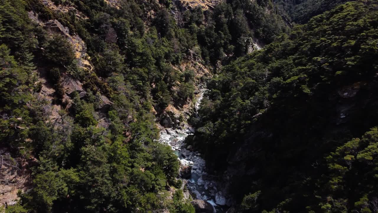AERIAL Shot of a Mountain River cutting through a Valley in South Island, New Zealand