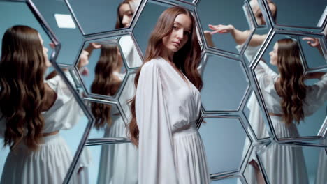 elegant woman with long hair reflected in hexagonal mirrors